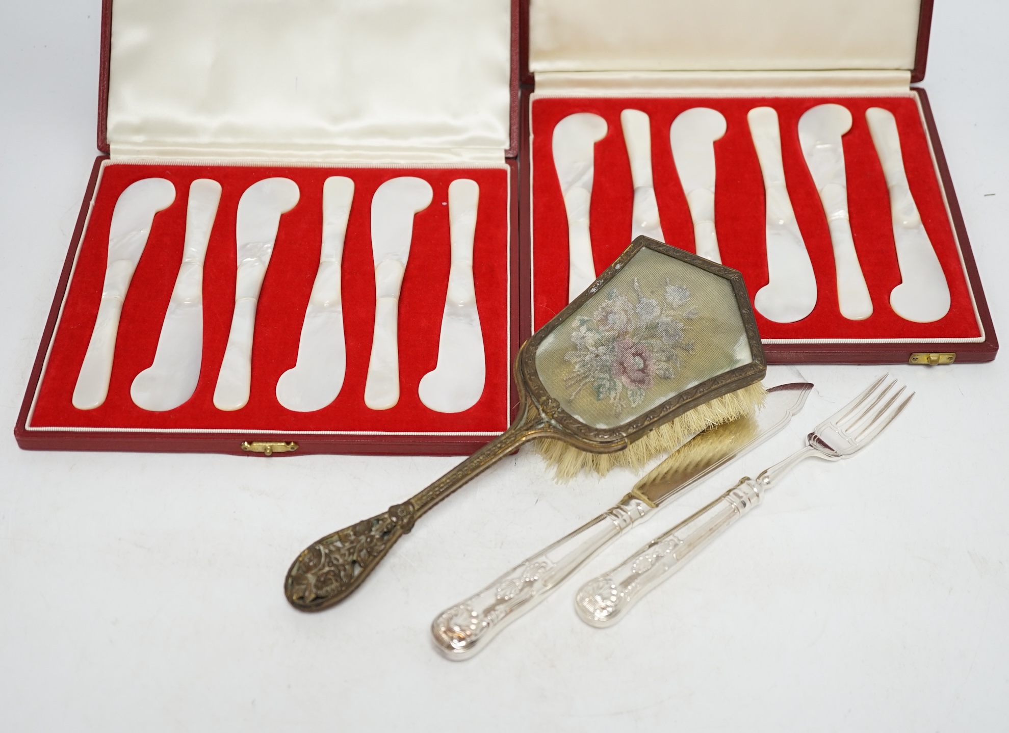 A quantity of plated ware including twelve pairs of fish eaters, a pair of sugar casters etc., together with two cased sets of six Asprey & Co mother of pearl butter knives. Condition - poor to fair to good